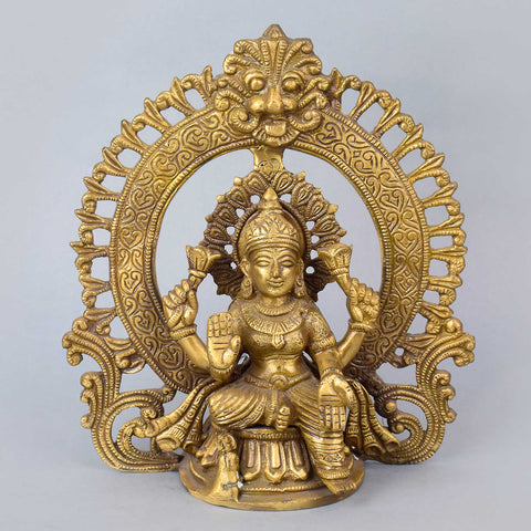 8.7 Inch Exquisite Pure Brass Goddess Lakshmi Idol with detailed Prabhaval arch, showcasing intricate craftsmanship and divine elegance for home temple or spiritual decor. No.1 Brass Idol Store www.satvikstore.in 
