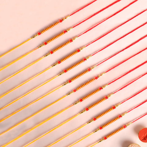 Assortment of 12 Rakhis, featuring different designs, threads, and embellishments for Raksha Bandhan. India’s Largest Pooja Accessories Brand - www.satvikstore.in